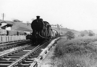 A "Stoke Scot" takes a down goods towards Macclesfield passing what is now the site of Cheddleton Motive Power Department