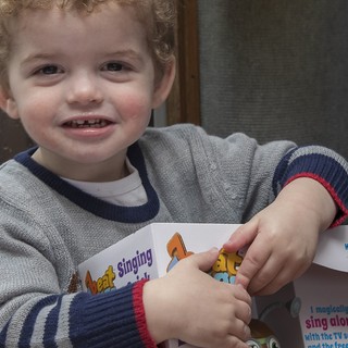 A very happy chappy getting stuck into his present from Santa